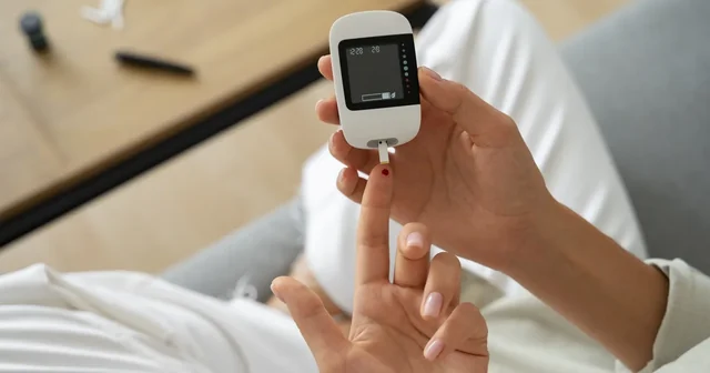 Diabetic woman checking her glucose level 1